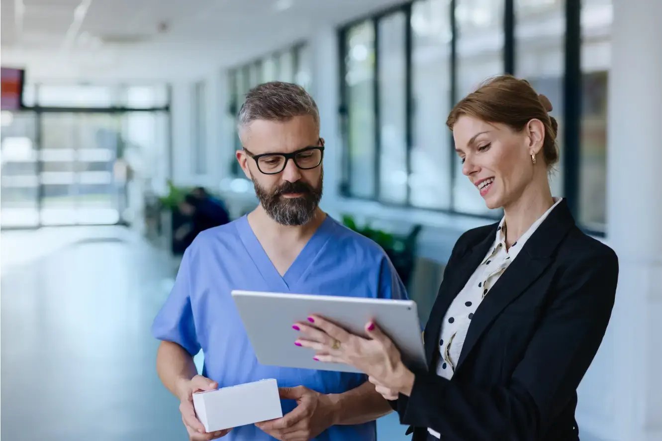 doctor and business woman looking at iPad together