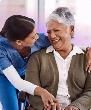 nurse hugging woman in wheelchair